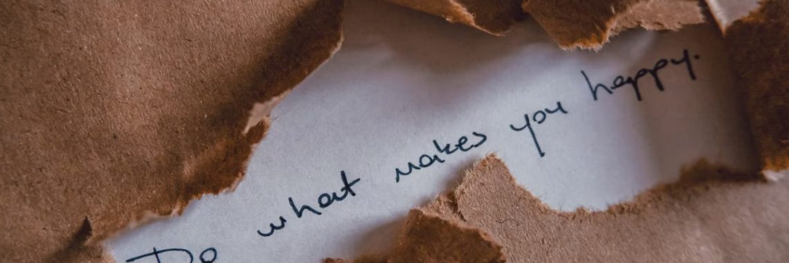 Brown paper revealing message 'Do what makes you happy.'